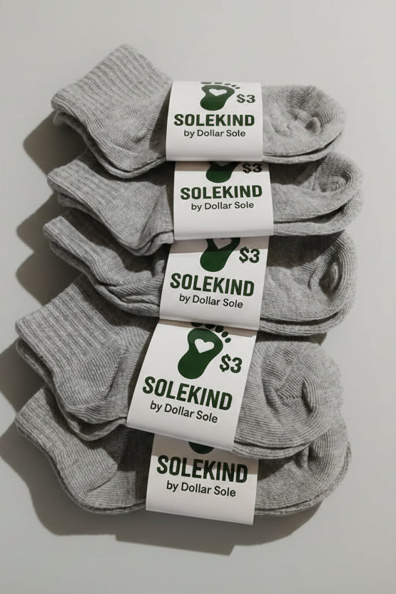 Gray socks with Solekind and Dollar Sole labels on a white background