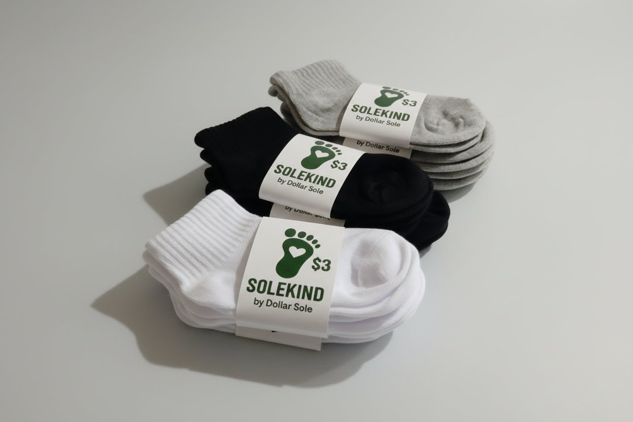 Stacks of black, white, and gray socks with 'Solekind' labels on a light gray background
